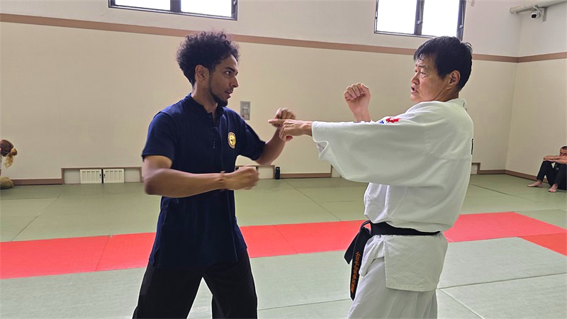 David Crespo exchanging martial arts techniques with a Japanese Karate master at Japan Osaka Kung Fu School in Osaka Japan